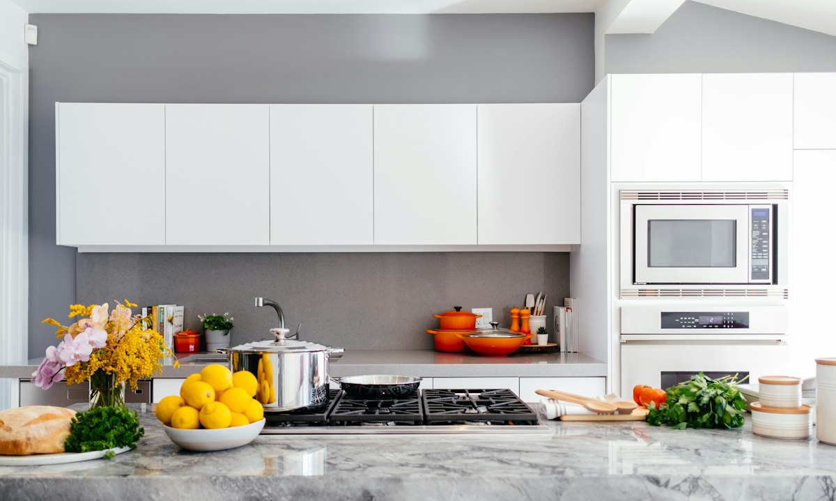 Bright domestic kitchen with a working counter and cooking equipment