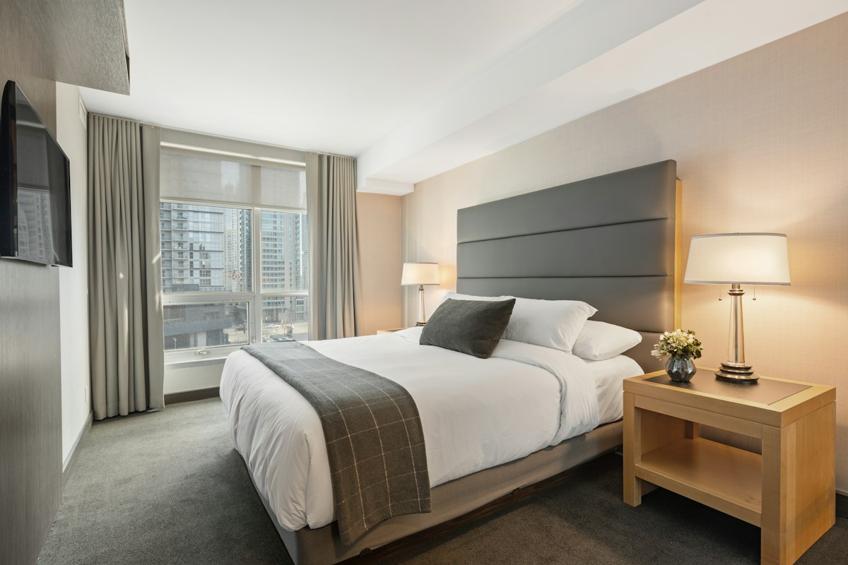 Inviting bed with layered light-colored bedding